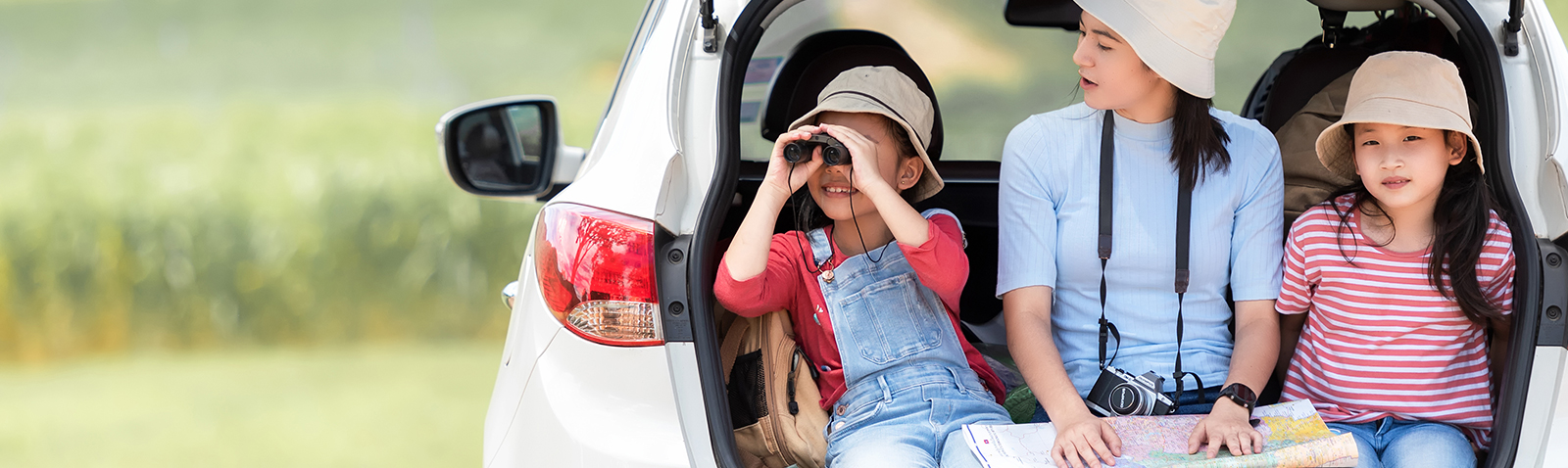 Family bird watching while sitting in back of car