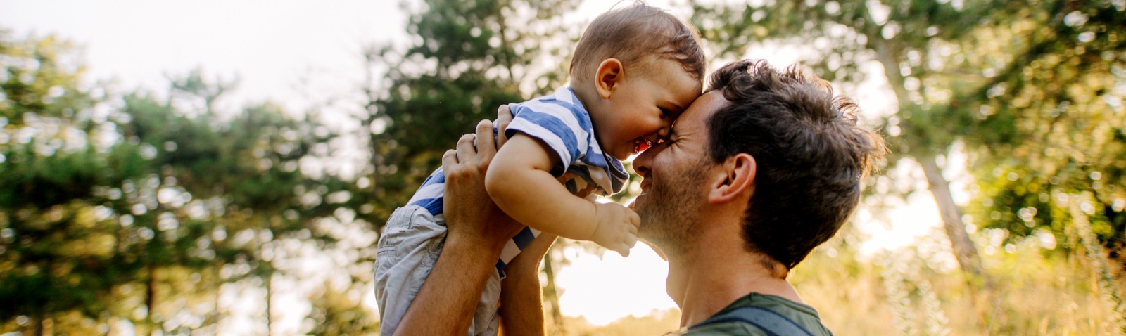 Parent holding a young child outdoors