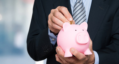 Putting coins in piggy bank