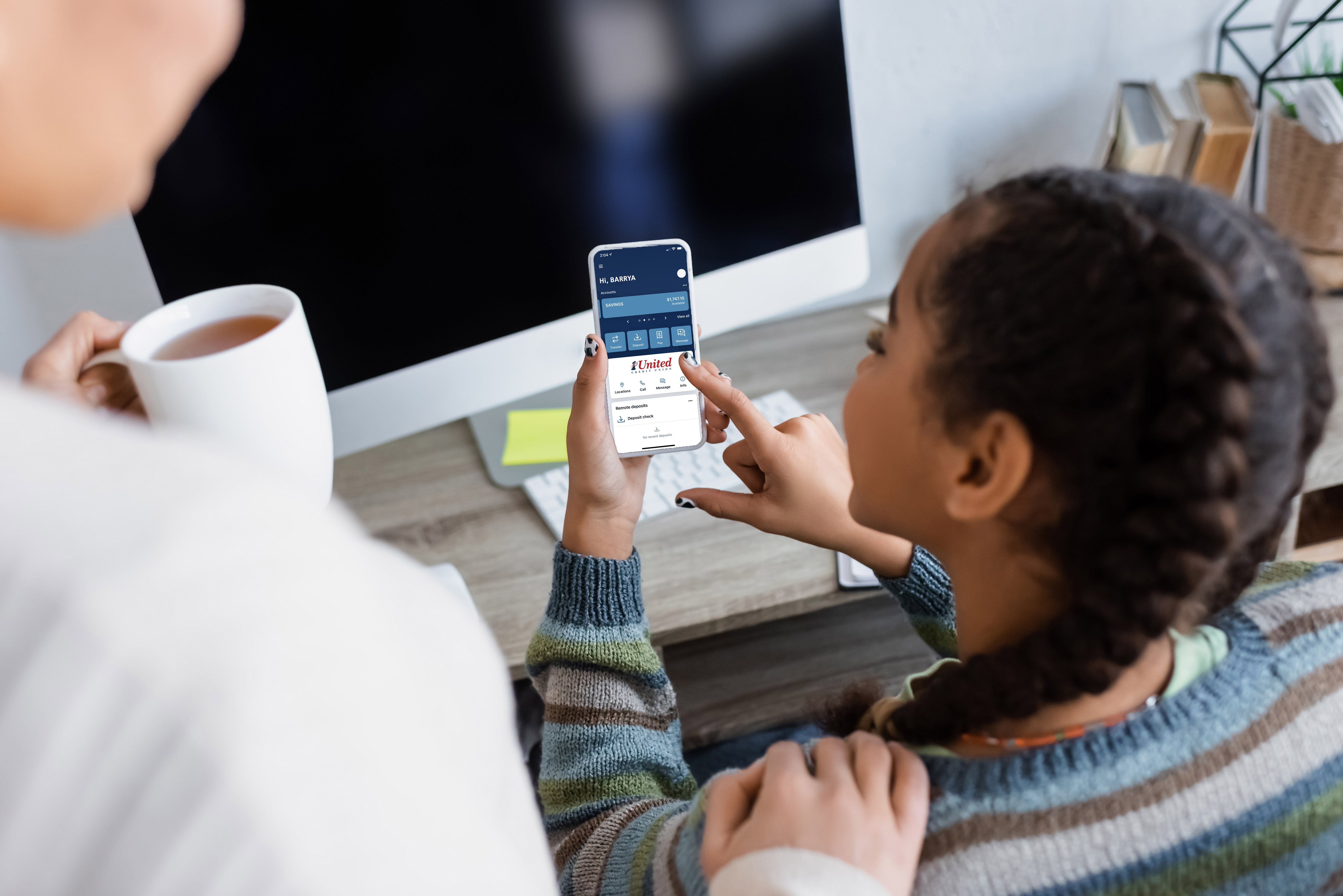 Young child on online banking on her phone
