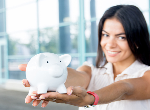 Young person holding piggy bank