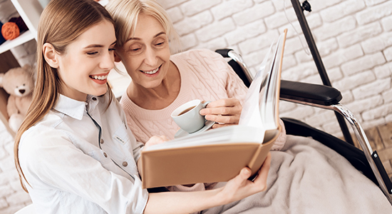 Care worker reading to the elderly