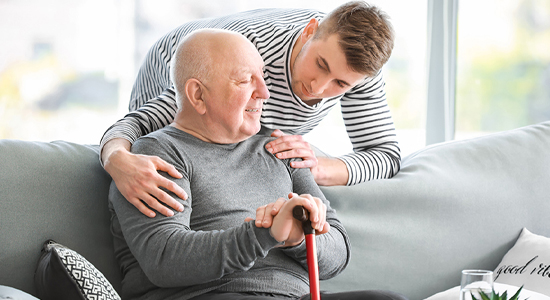 Family member speaking with elderly grandfather