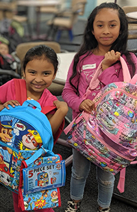 Local youth picking up backpacks