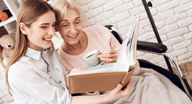 Care worker reading to the elderly