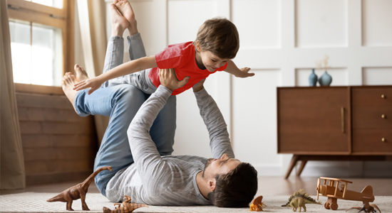 Father and son playing in living room