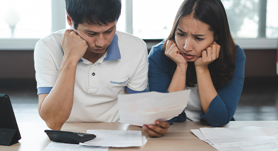 Concerned couple reading papers