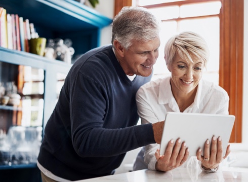 couple using tablet device in kitchen