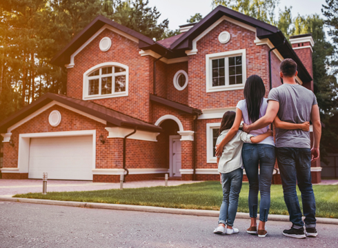 Family outside their new home