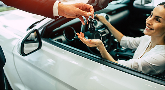 Person receiving the keys to their new car