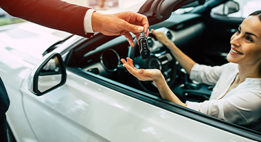 Person receiving the keys to their new car