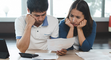 Concerned couple reading statements