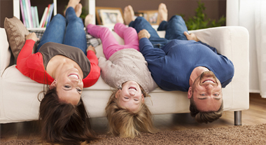 Family hanging upside down on couch