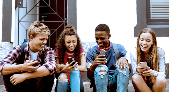 Group of teens using cell phones